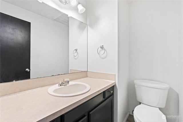 bathroom featuring vanity and toilet