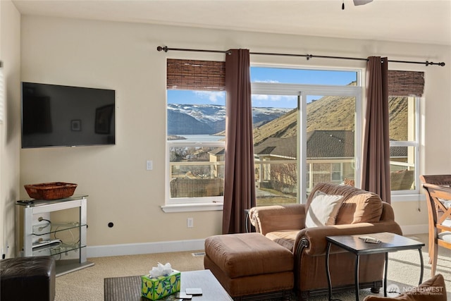 carpeted living room featuring baseboards