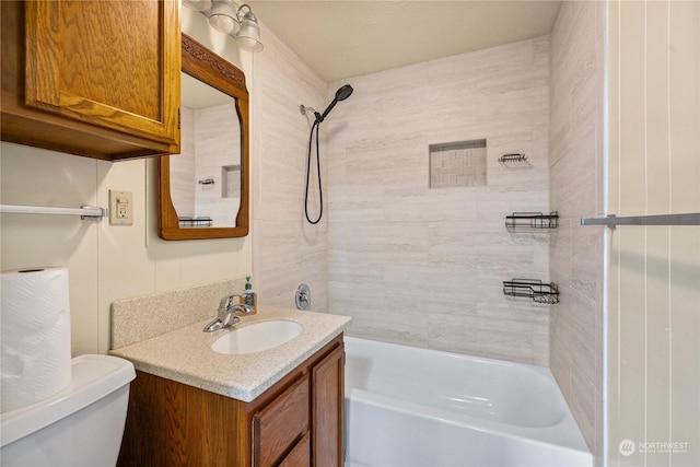 full bathroom with vanity, tiled shower / bath combo, and toilet