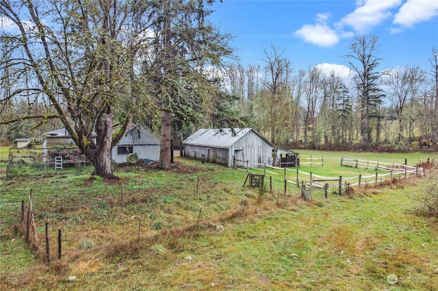 view of yard featuring a rural view and an outdoor structure