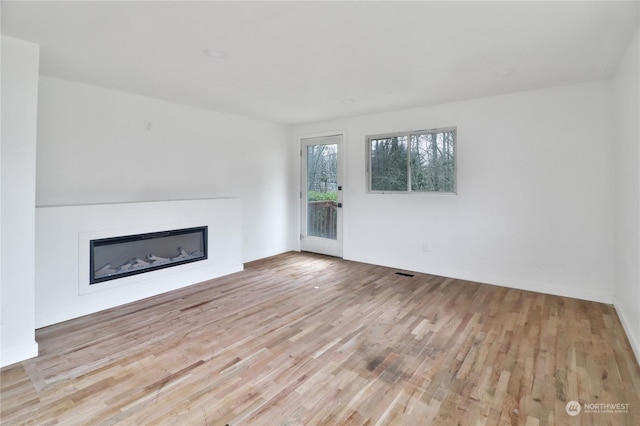 unfurnished living room featuring light hardwood / wood-style flooring