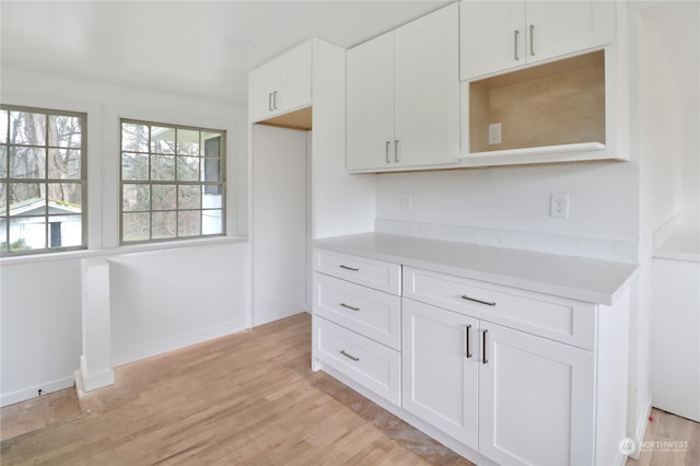 kitchen featuring white cabinets and light hardwood / wood-style flooring