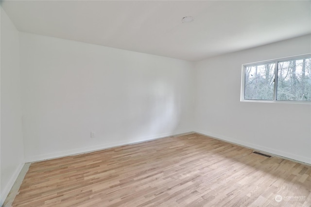 empty room with light hardwood / wood-style floors