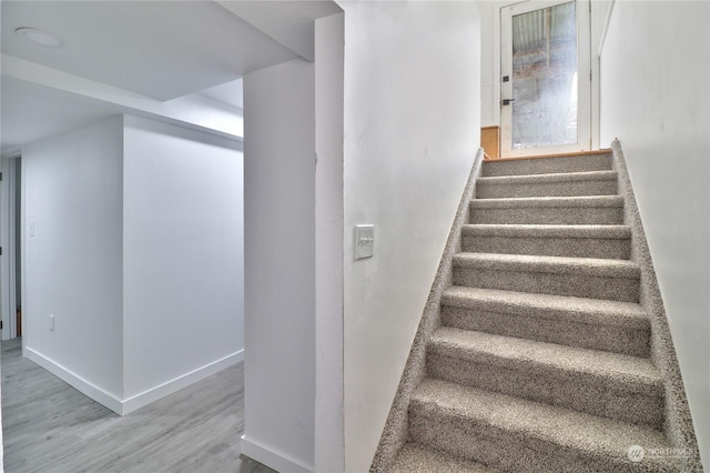 stairway with hardwood / wood-style flooring