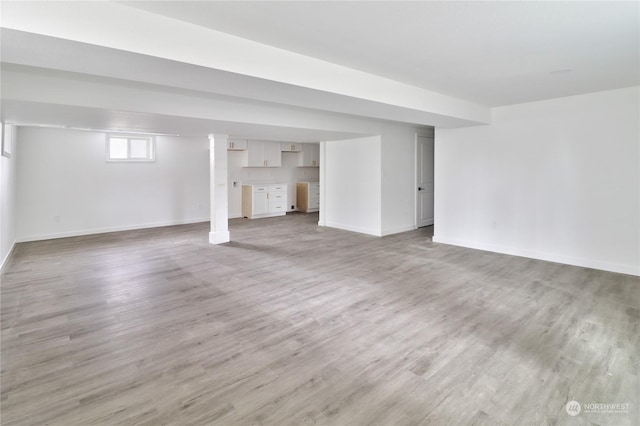 basement with light hardwood / wood-style floors