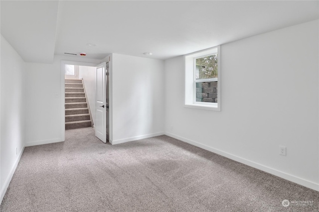 basement featuring light colored carpet