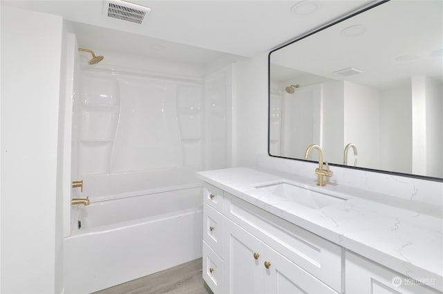 bathroom featuring bathing tub / shower combination, wood-type flooring, and vanity