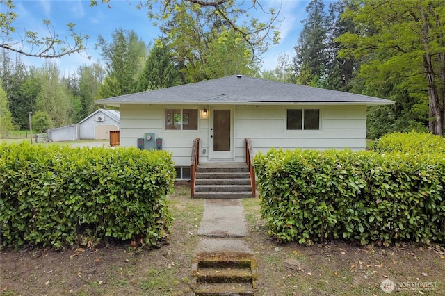 bungalow-style house featuring a shingled roof