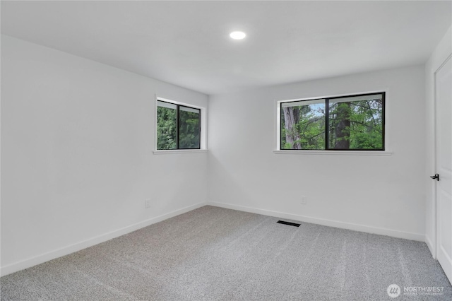 empty room with carpet floors, baseboards, and recessed lighting