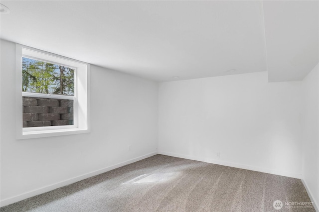 carpeted empty room with baseboards