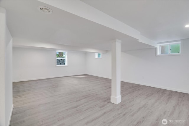 basement featuring wood finished floors and baseboards