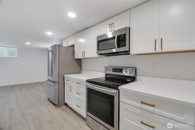 kitchen featuring appliances with stainless steel finishes, light wood-style floors, white cabinets, recessed lighting, and baseboards
