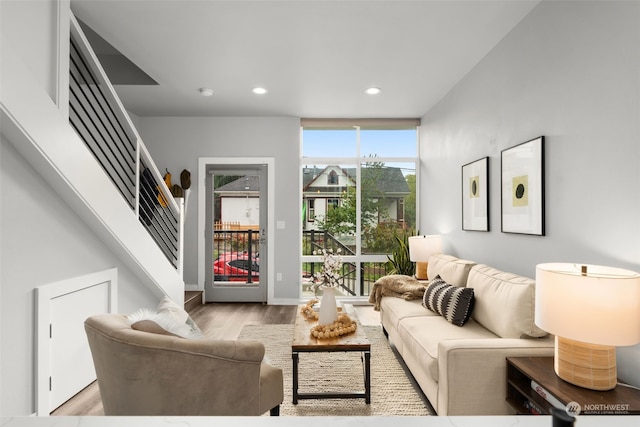 living room featuring a wall of windows and light wood-type flooring