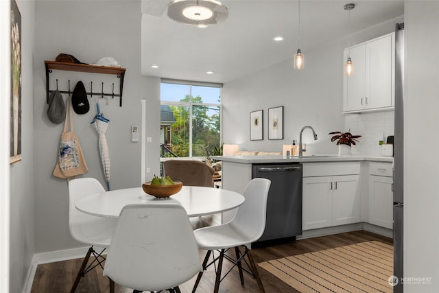 dining space featuring dark hardwood / wood-style flooring and sink