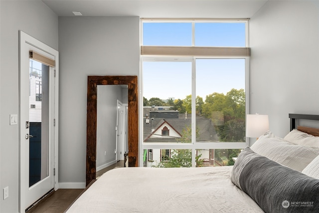 bedroom featuring dark wood-type flooring and multiple windows