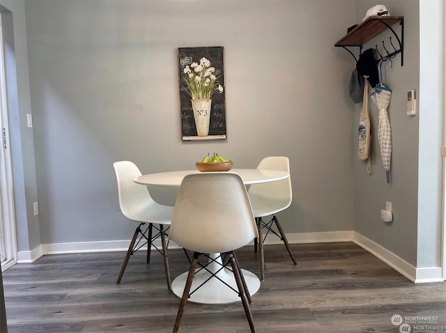 dining room with dark hardwood / wood-style floors