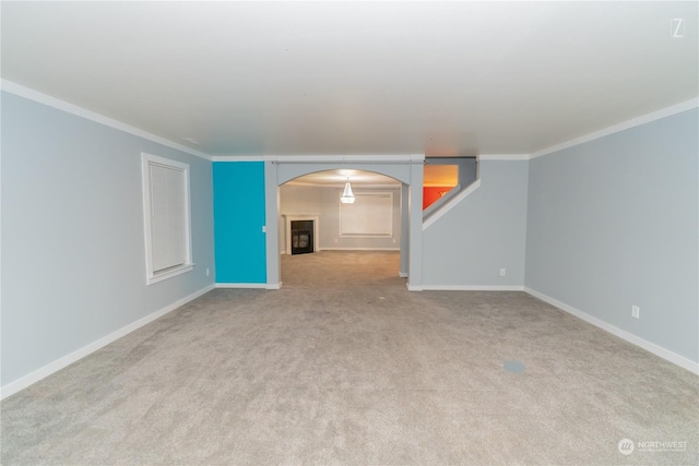 unfurnished living room featuring crown molding and light colored carpet