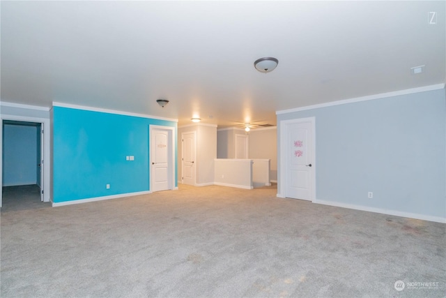 unfurnished living room with ornamental molding and light carpet