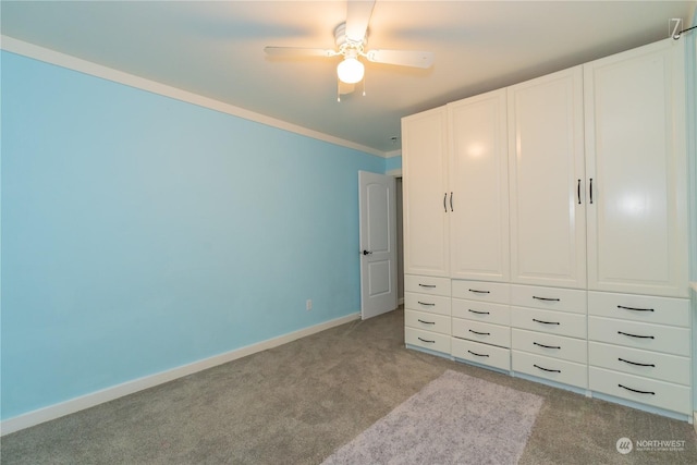 unfurnished bedroom featuring ceiling fan, a closet, light carpet, and ornamental molding