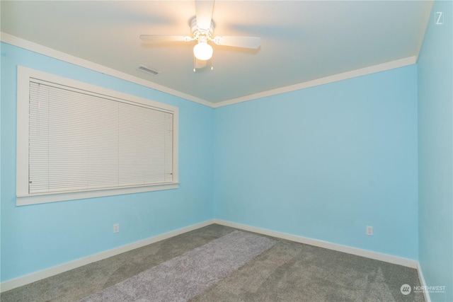 carpeted spare room with ceiling fan and crown molding