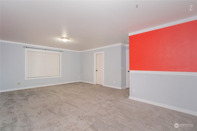 spare room with ornamental molding and light carpet