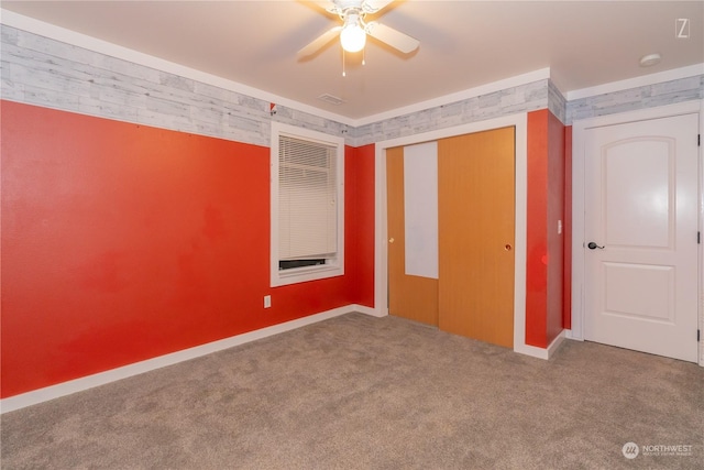 unfurnished bedroom with carpet flooring, ceiling fan, and a closet