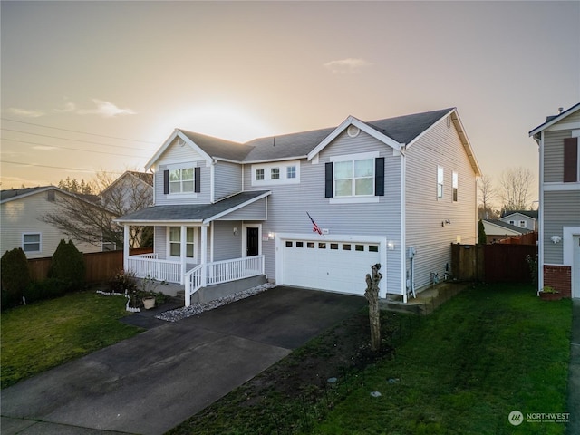 view of property with covered porch, a yard, and a garage