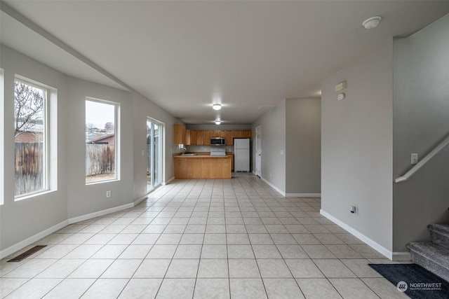 unfurnished living room featuring light tile patterned floors