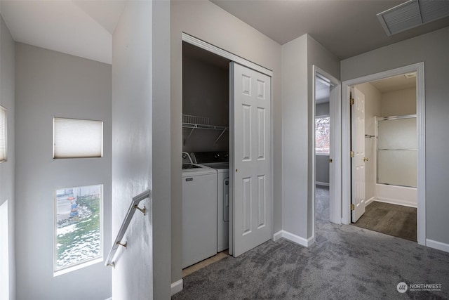 laundry area featuring dark colored carpet and washing machine and clothes dryer