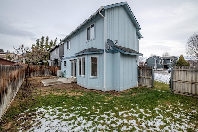 back of property with a lawn, cooling unit, and a patio