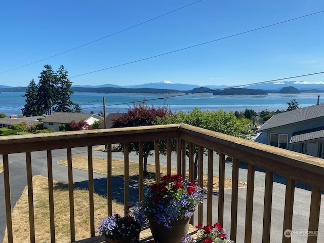 balcony with a water and mountain view