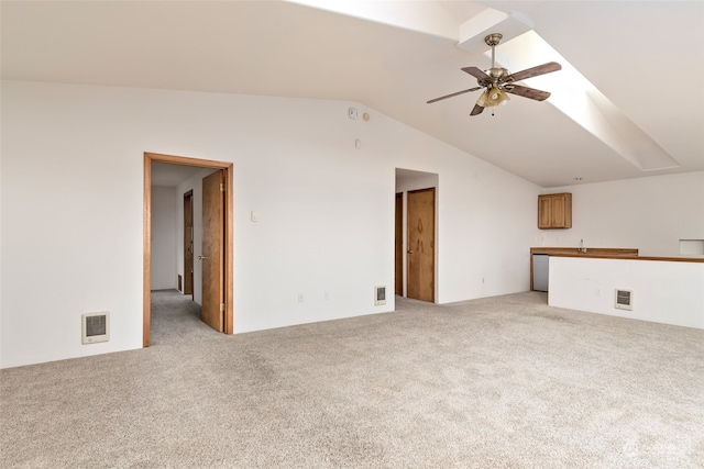 unfurnished living room with ceiling fan, light colored carpet, and lofted ceiling