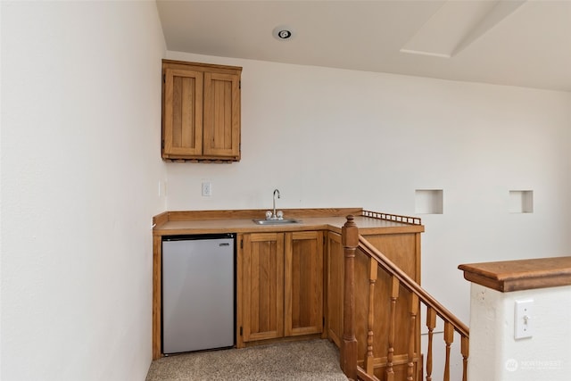 bar with sink and refrigerator