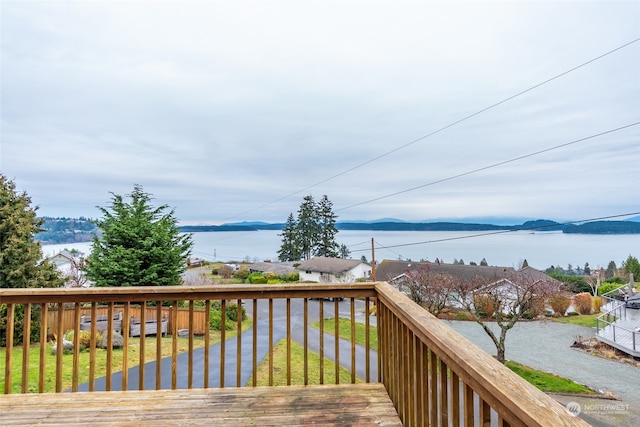 wooden terrace with a water and mountain view