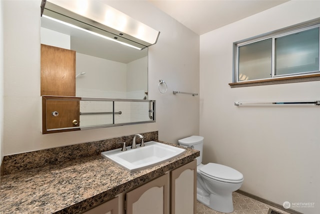 bathroom featuring vanity and toilet