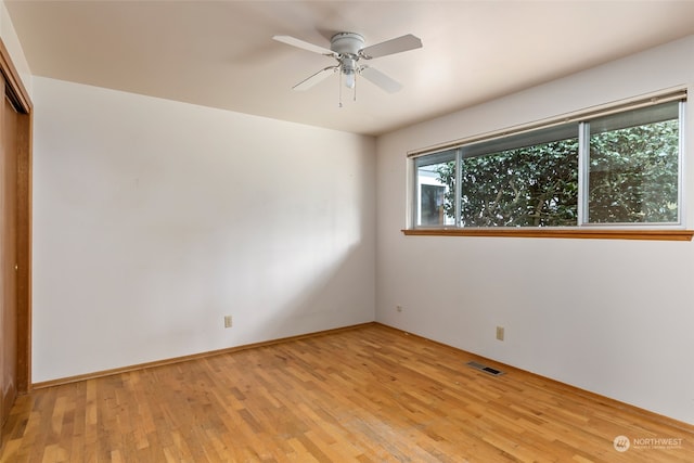 unfurnished room featuring ceiling fan and light wood-type flooring