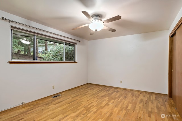 spare room featuring light hardwood / wood-style flooring and ceiling fan