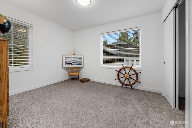 unfurnished bedroom with light carpet and a closet