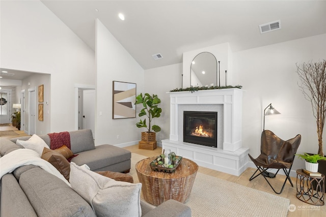 71 Plateau Loop, Cle Elum, WA 98922 - living room with light wood-style floors, a glass covered fireplace, recessed lighting, and high vaulted ceiling