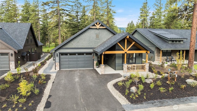 71 Plateau Loop, Cle Elum, WA 98922 - view of front of property with asphalt driveway, an attached garage, a porch, and stone siding