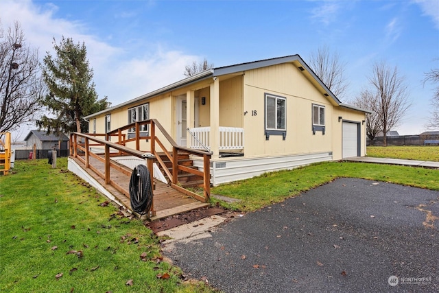 view of front of property featuring a garage and a front lawn