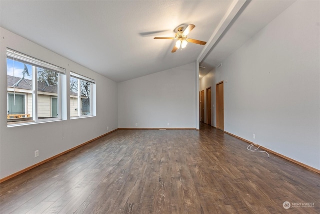 empty room with ceiling fan, dark hardwood / wood-style flooring, and vaulted ceiling