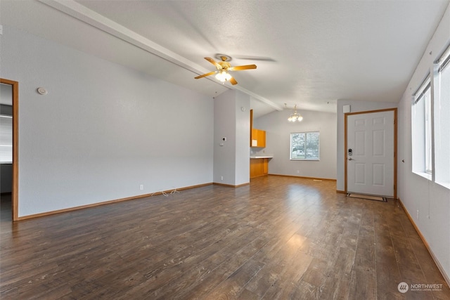 unfurnished living room featuring ceiling fan with notable chandelier, vaulted ceiling, and dark wood-type flooring