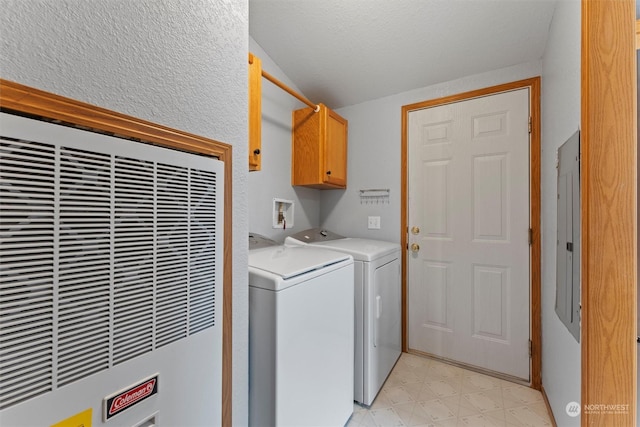 laundry area featuring washer and clothes dryer and cabinets