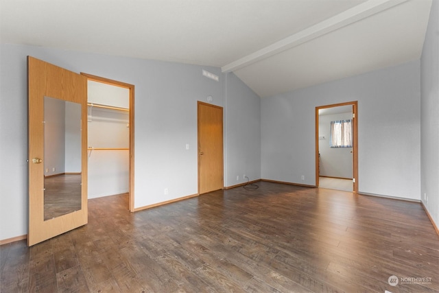 empty room with lofted ceiling with beams and dark hardwood / wood-style floors