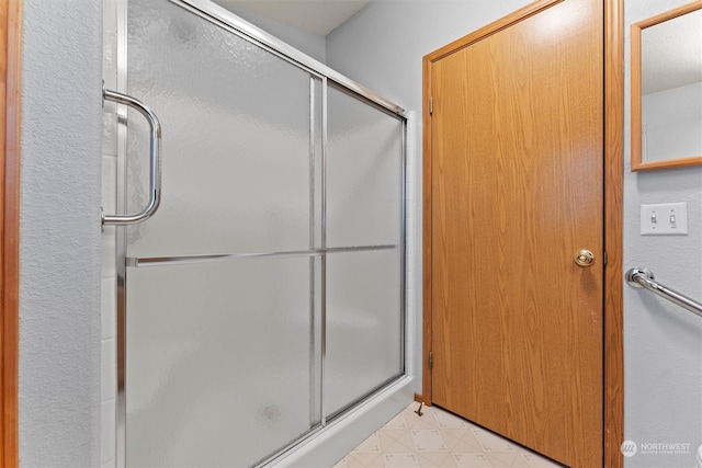 bathroom featuring an enclosed shower