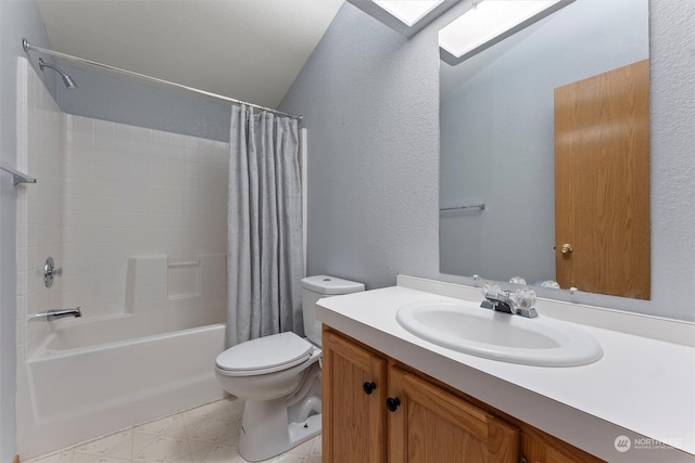 full bathroom featuring shower / tub combo, vanity, toilet, and vaulted ceiling with skylight