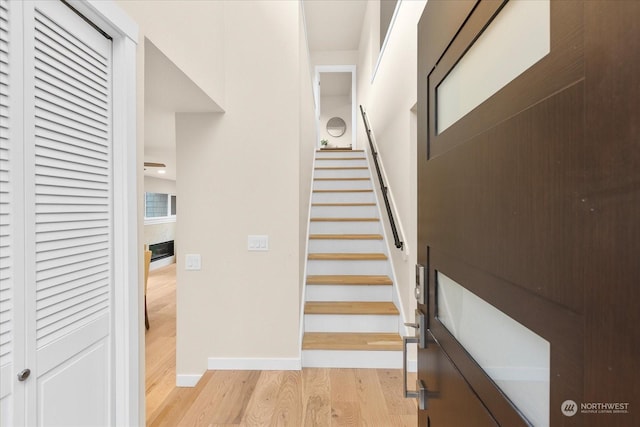 staircase with hardwood / wood-style flooring