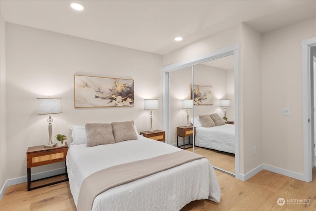 bedroom with wood-type flooring and a closet