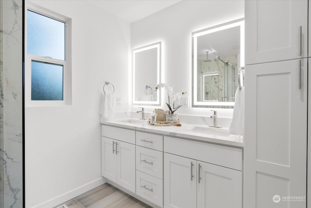 bathroom with vanity, a shower with shower door, and hardwood / wood-style flooring